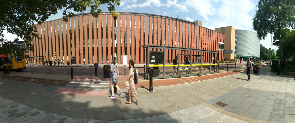 A panoramic picture of the Kilburn building taken from the Oxford Road. The building stands next to University Place, shown in the right of the picture here, which looks a bit like a giant tin of baked beans.